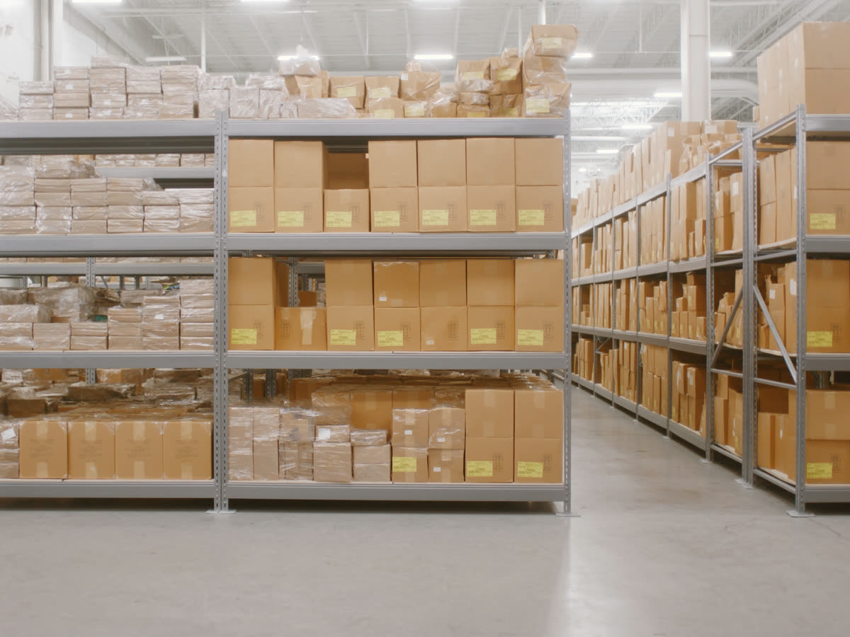 Organized warehouse shelving stacked with stored packages